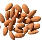 almond oil bottle with measuring tape and almonds